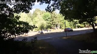 A woman teaches how to squirt on the city sidewalk in the park