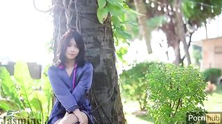 A cute Asian girl masturbates in the garden with a vibrator and dildo