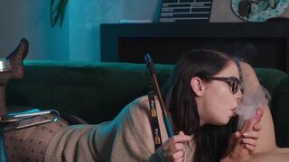 A young girl wearing glasses gets her big hole watered by a guy in 69 position