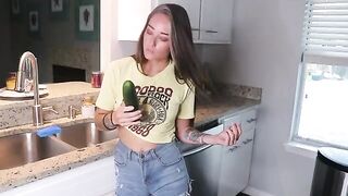 The appetizing beauty has a little snack before lunch in the kitchen