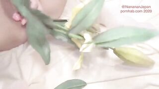 A cute girl puts flowers in her ass while a guy fucks her in the ass