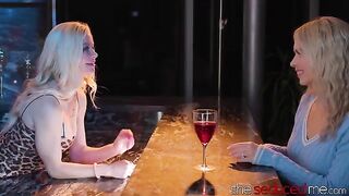 The girl is being served drinks by a hot lesbian bartender