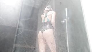 She took a shower and rubbed her pussy until she came with jets of water