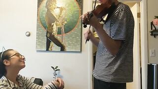 The guy tried to practice the violin, but the girl interrupted him with her hand