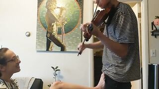 The guy tried to practice the violin, but the girl interrupted him with her hand