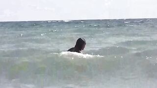 A group of girls are enjoying sunbathing naked on the beautiful beach