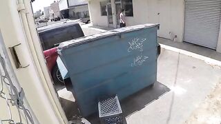 A naked girl was photographed having sex behind a garbage tank