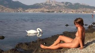 Nudist beauty has sex on the riverbank in this hot video