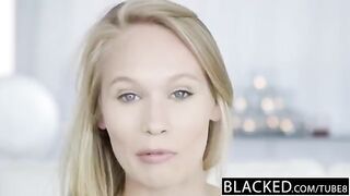 A young blonde girl is fucked by a negro on the couch at casting
