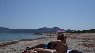 A blowjob in public place on the beach is too much to resist