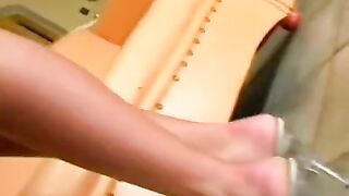 A nice woman masturbates in a leather chair, showcasing her solo skills
