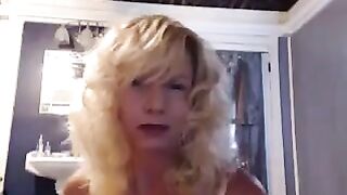 A mature woman caresses herself in the bathroom, feeling pleasant sensations