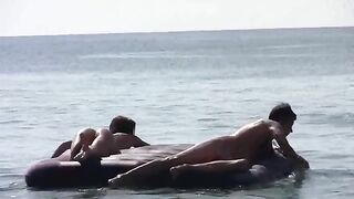 A naked girl is having fun on the sandy coast of the sea