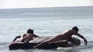A naked girl is having fun on the sandy coast of the sea