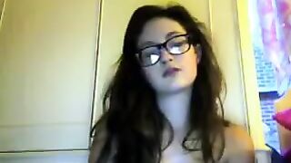A student with glasses plays and shows her boobs in a video chat