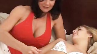 A young girl is having fun with her mature girlfriend using a strapon