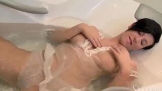 Lonely brunette caresses her pussy under the shower head