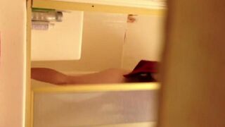 A hidden camera captures a girl washing in the shower