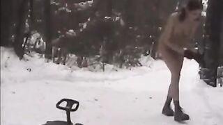 Nude girls are having fun with snowballs on the street
