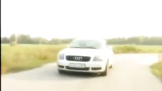 A girl with a bare pussy sits on the bonnet and shakes it