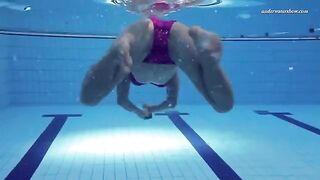 A hot naked girl is swimming in the pool
