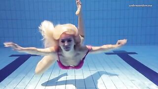A hot naked girl is swimming in the pool