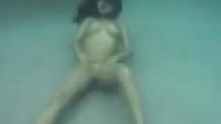 Busty brunette beauty enjoys sex right in the ocean