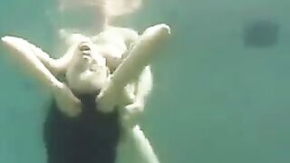 Busty brunette beauty enjoys sex right in the ocean