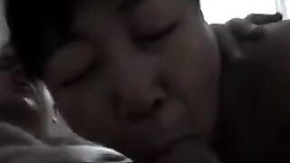 An appetizing Chinese woman practices her skills in giving a blowjob