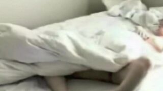 A guy masturbates naked in the bedroom, unaware of a camera
