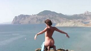 A girl is fond of posing naked on the beautiful beach