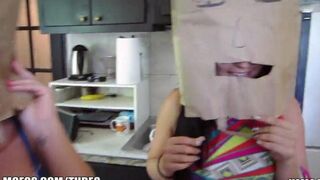The girls wear bags on their heads while having fun