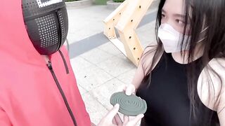 Asian woman participates in a twisted version of the Squid Game and engages in passionate action