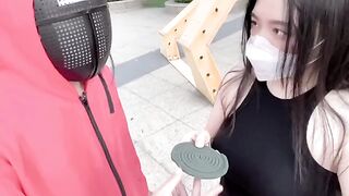 Asian woman participates in a twisted version of the Squid Game and engages in passionate action