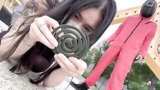 Asian woman participates in a twisted version of the Squid Game and engages in passionate action