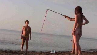 A girl is fucking with her guy on the public naked beach