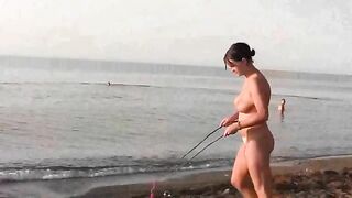 A girl is fucking with her guy on the public naked beach