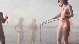 A girl is fucking with her guy on the public naked beach