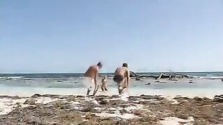 Blonde woman has sex on the beach with two guys