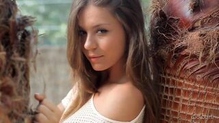 A young Russian woman takes off her clothes and dances eroticly