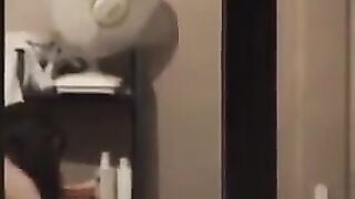 A hot guy admires himself in the mirror, completely naked, with a big dick