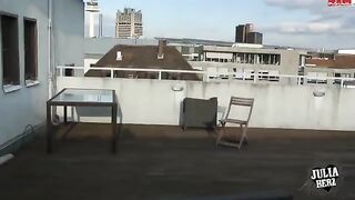 A hot brunette with big tits bounces on the cock on the roof terrace in HD