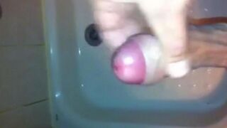 The kid caresses his dick under the shower jet, trying to bring himself to a strong orgasm