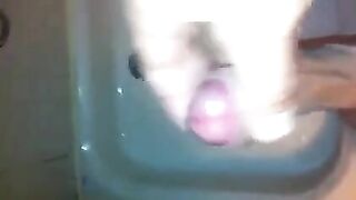The kid caresses his dick under the shower jet, trying to bring himself to a strong orgasm
