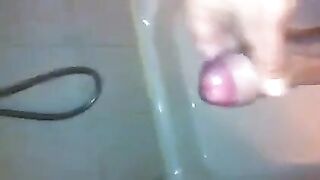 The kid caresses his dick under the shower jet, trying to bring himself to a strong orgasm