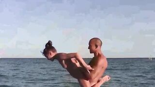 Nude acrobats are fucking on the naked beach
