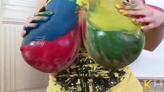 A hot artistic woman with big tits masturbates using a toy
