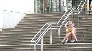 A girl walks on the street without panties and a bra