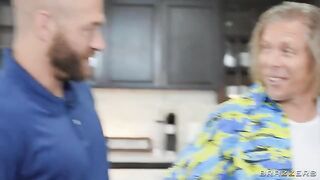 A blonde with big tits is in a threesome, receiving attention from two men