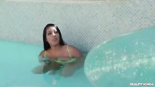 A sexy girl has swimming lessons in the pool with a guy